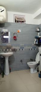 a bathroom with two toilets and a sink at Alavyahomestay in Kilba +4 photos