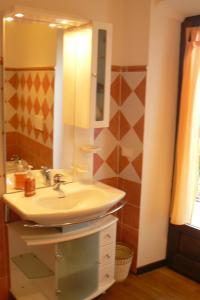 a bathroom with a sink and a mirror at B&B BORGATO in Mondovì