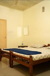 a bedroom with two beds in a room at Palm Grove Service Villa in Cochin