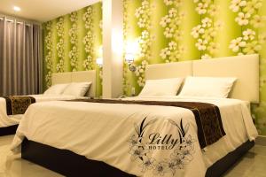 Postel nebo postele na pokoji v ubytování Lilly Hotel