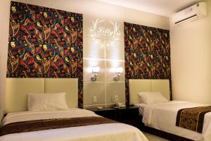 Postel nebo postele na pokoji v ubytování Lilly Hotel