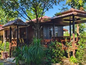 a home with a large wooden house at Thakrayang Brass Artisan Home Stay in Ban Tha Krayang