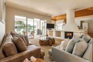 a living room with two couches and a fireplace at Meelup Vista in Dunsborough