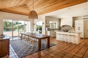 a kitchen with a large wooden table and chairs at Meelup Vista in Dunsborough