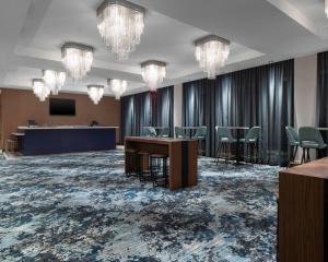 a conference room with chairs and a table and chandeliers at Hyatt Place Allentown - Lehigh Valley in Allentown