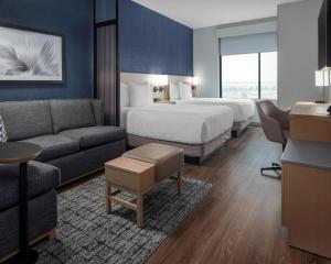 a hotel room with two beds and a couch at Hyatt Place Allentown - Lehigh Valley in Allentown +22 photos