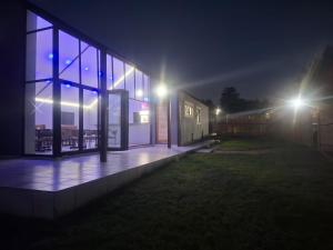 a building with lights on the side of it at night at Nu Oasis guest house in Johannesburg