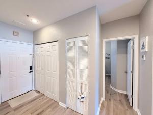 a hallway with two white doors and wooden floors at Lakeside Sunrise Water Views in Camdenton