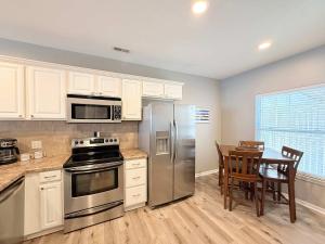 a kitchen with stainless steel appliances and a table at Lakeside Sunrise Water Views in Camdenton