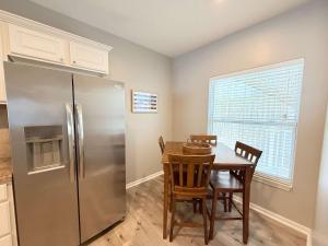 a kitchen with a table and a refrigerator at Lakeside Sunrise Water Views in Camdenton