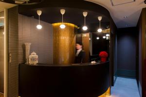 a person sitting at a reception desk in a lobby at Hotel COREST (Adult Only) in Tokyo