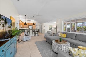 a large living room with a couch and a kitchen at Enclosed pool spa - Stillpoint by SeaBreeze Vacation in Holmes Beach