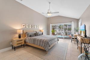 a bedroom with a bed and a table with a desk at Enclosed pool spa - Stillpoint by SeaBreeze Vacation in Holmes Beach +36 photos