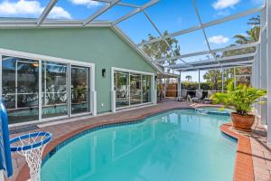 an indoor swimming pool with a glass ceiling at Enclosed pool spa - Stillpoint by SeaBreeze Vacation in Holmes Beach