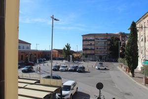 a street with cars parked in a parking lot at La Stazione #1 in Pontedera