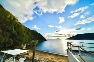 a view of a beach next to a body of water at ALY HOTEL See Sea Son in Kure