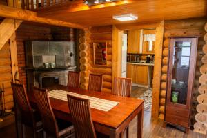 a kitchen and dining room with a wooden table and chairs at Artunpirtti in Keuruu