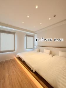 a bedroom with two beds and a sign that reads follower base at Flower Base HIMAWARI in Fukuoka