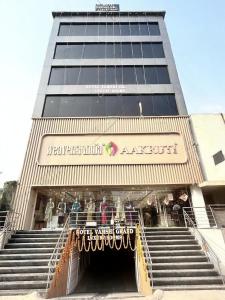 a large building with stairs leading into a store at Hotel Vamshi Grand in Lingampalli