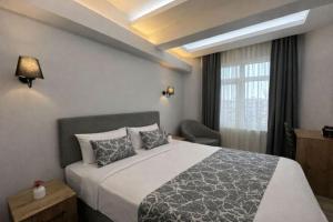 a bedroom with a large bed and a window at Medi Otel in Samsun