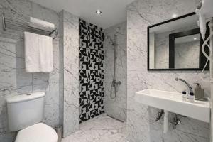 a bathroom with a toilet and a sink and a mirror at Medi Otel in Samsun