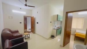 a living room with a couch and a chair at Sign Valley in Cochin +43 photos