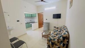 a living room with a couch and a sink at Sign Valley in Cochin