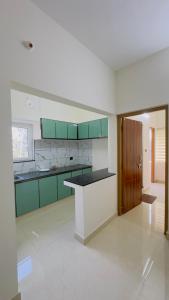 a kitchen with green cabinets and a counter top at Sign Valley in Cochin