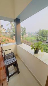 a balcony with a bench in front of a window at Sign Valley in Cochin