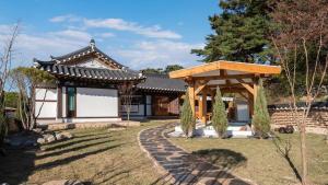 a house with a gazebo in a yard at Gyeongju Oru Hanok Stay in Gyeongju