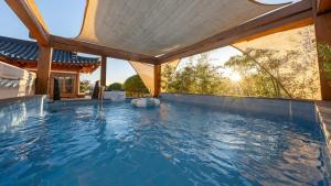 an indoor swimming pool with a large roof at Gyeongju Oru Hanok Stay in Gyeongju