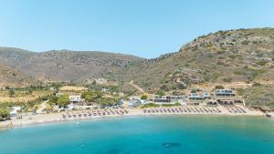 Luftaufnahme eines Strandes mit Liegestühlen und Gebäuden in der Unterkunft Spathi Beach Suites Kea in Spathi 