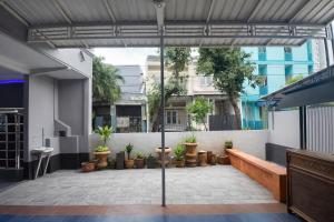 an outdoor patio with potted plants and an umbrella at Residence 168 in Gununganjar