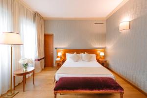 Łóżko lub łóżka w pokoju w obiekcie Windsor Hotel Milano