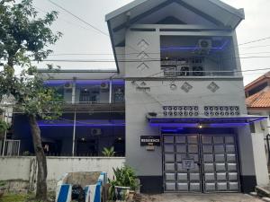 a building with blue and white paint on it at Residence 168 in Gununganjar +20 photos