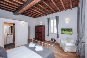 a bedroom with a bed and a living room at Trastevere Premium Apartment in Rome