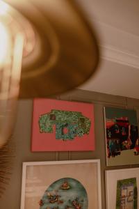 eine Gruppe von Bildern, die an einer Wand hängen in der Unterkunft Ambiance Boutique Art Hotel Lahore in Lahore