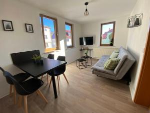 a living room with a table and a couch at Forrest Lounge Schweina in Bad Liebenstein