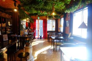 a restaurant with tables and chairs in a room at はじまりの宿 ディール in Tsumagoi