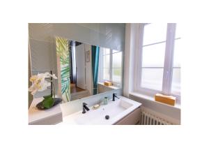 a bathroom with a sink and a mirror at Chez Fabienne et Olivier, chambre privative avec SDB et WC, Avranches Baie du Mont Saint Michel in Avranches