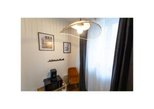 a room with a light and a mirror and a chair at Chez Fabienne et Olivier, chambre privative avec SDB et WC, Avranches Baie du Mont Saint Michel in Avranches +14 photos