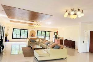 a living room with a couch and a table at Torres Farm Resort powered by Cocotel in Naic