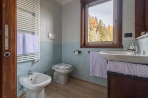a bathroom with a sink and a toilet and a window at Oga View Apartment in Oga +19 photos