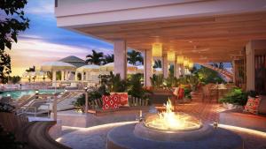 a resort with a fire pit and a pool at The Sunny in Sunny Isles Beach