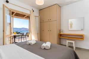 a bedroom with a bed and a view of the ocean at Stay in Falassarna Rooms & Apartments in Falasarna