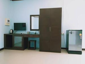 an office with a desk and a refrigerator in a room at ทิพ ทิพ รีสอร์ท ถ้ำเสือ in Ban Krabi Yai