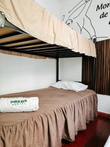 a bed with a canopy in a room at Hostel Prada in Lima