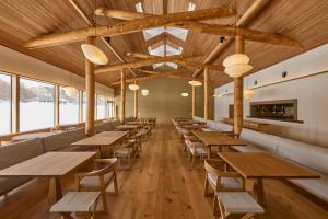 a row of tables and benches in a restaurant at AZUMA FARM Koiwai in Shizukuishi