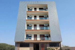 an apartment building with balconies on the side of it at Super Townhouse HOTEL SPR ROAD in Gurgaon