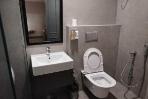 a bathroom with a toilet and a sink at Super Townhouse HOTEL SPR ROAD in Gurgaon